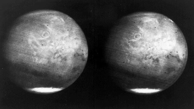 Two black and white full-disc views of Mars, each with a bright south polar cap.